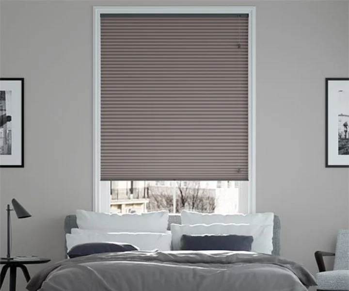Modern pleated blind installed in a bright window